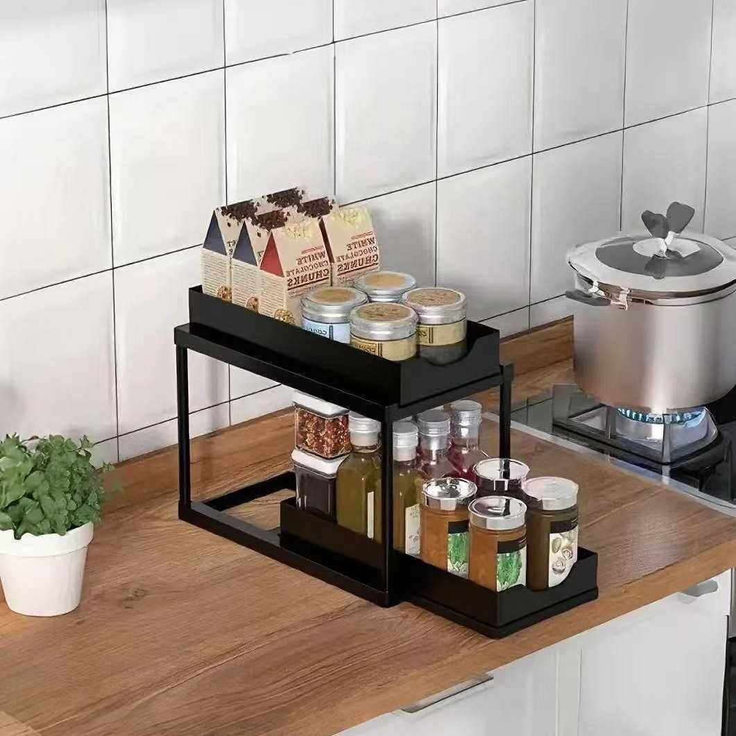 BLACK Two-tier pull-out storage rack. An organizational lifesaver for under the kitchen sink. Features adjustable shelves for easy storage of bottles and jars. In a sleek, modern design. Perfect as a kitchen shelf, bathroom organizer, or household storage